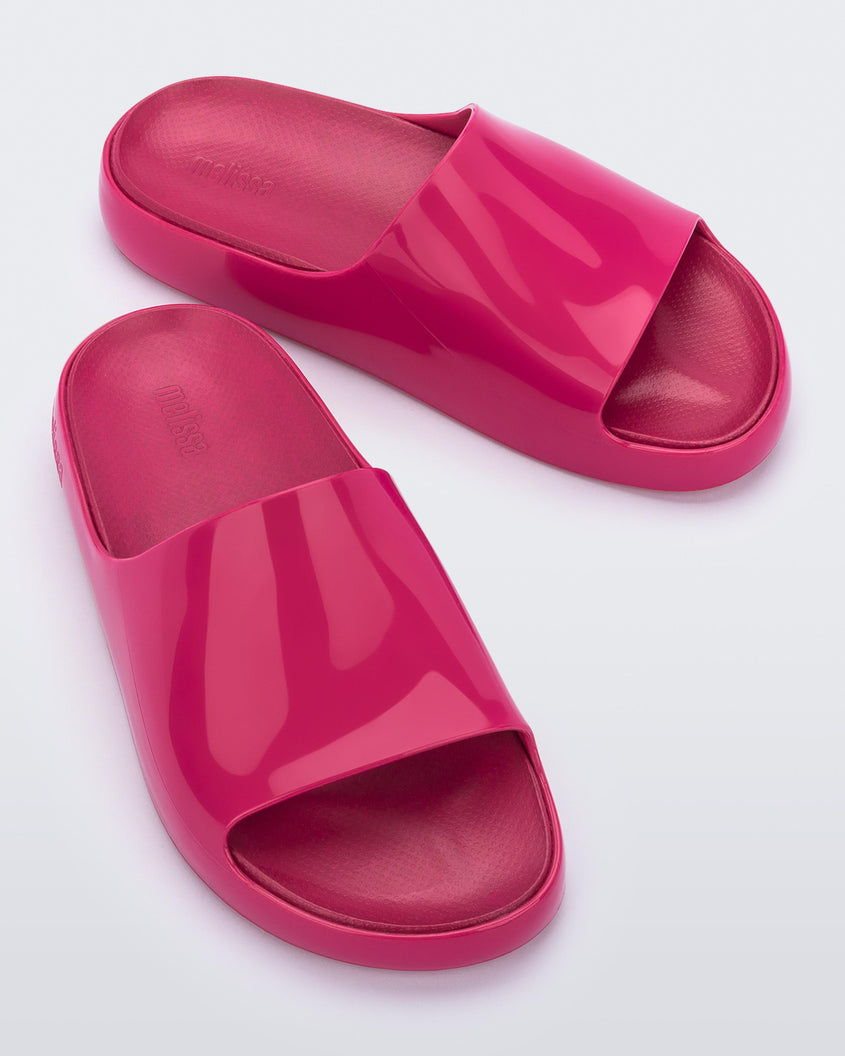 Top front view of a pair of pink Melissa Cloud slides.