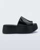 Side view of a black Melissa Becky platform slide. 
