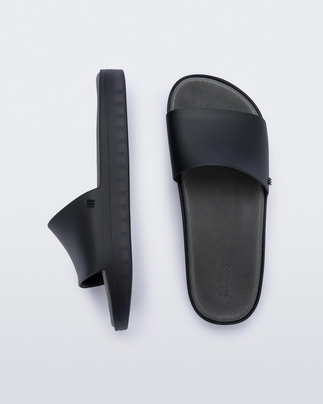 Top and side view of a pair of black Melissa Beach slides.