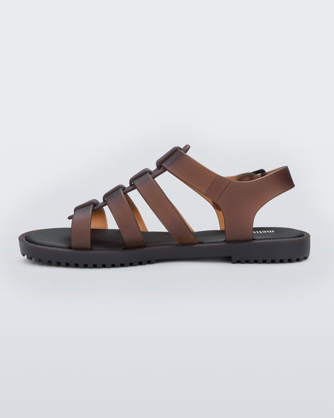 Inner side view of a clear brown Melissa Flox sandal with straps.