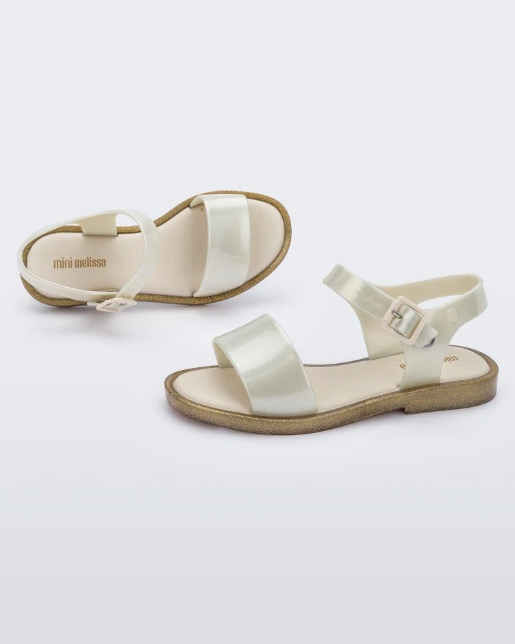 Top and side view of pair of pearly beige Mini Melissa Mar Sandals.