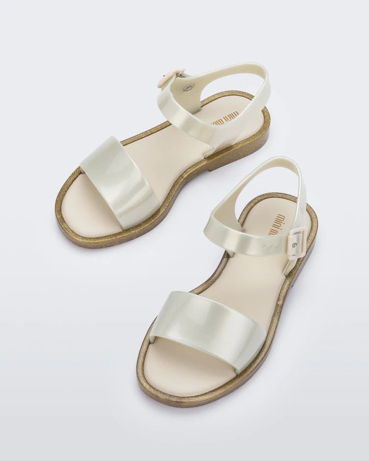 Angled view of a pair of pearly beige Mini Melissa Mar Sandals.