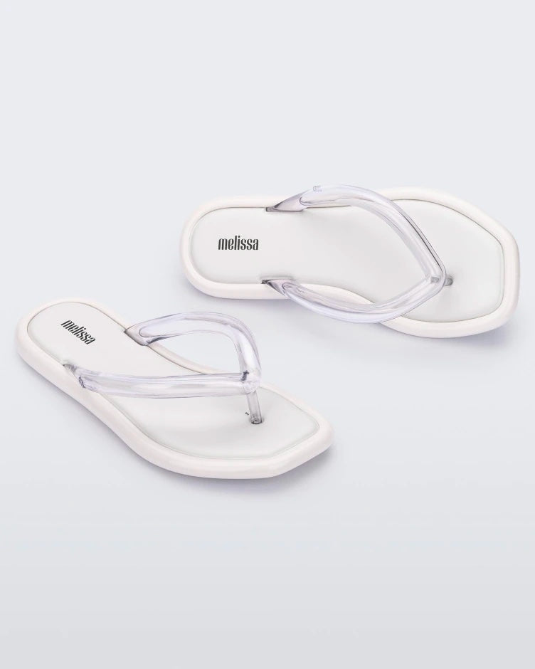 Angled view of a pair of white Melissa Airbubble Flip Flops.