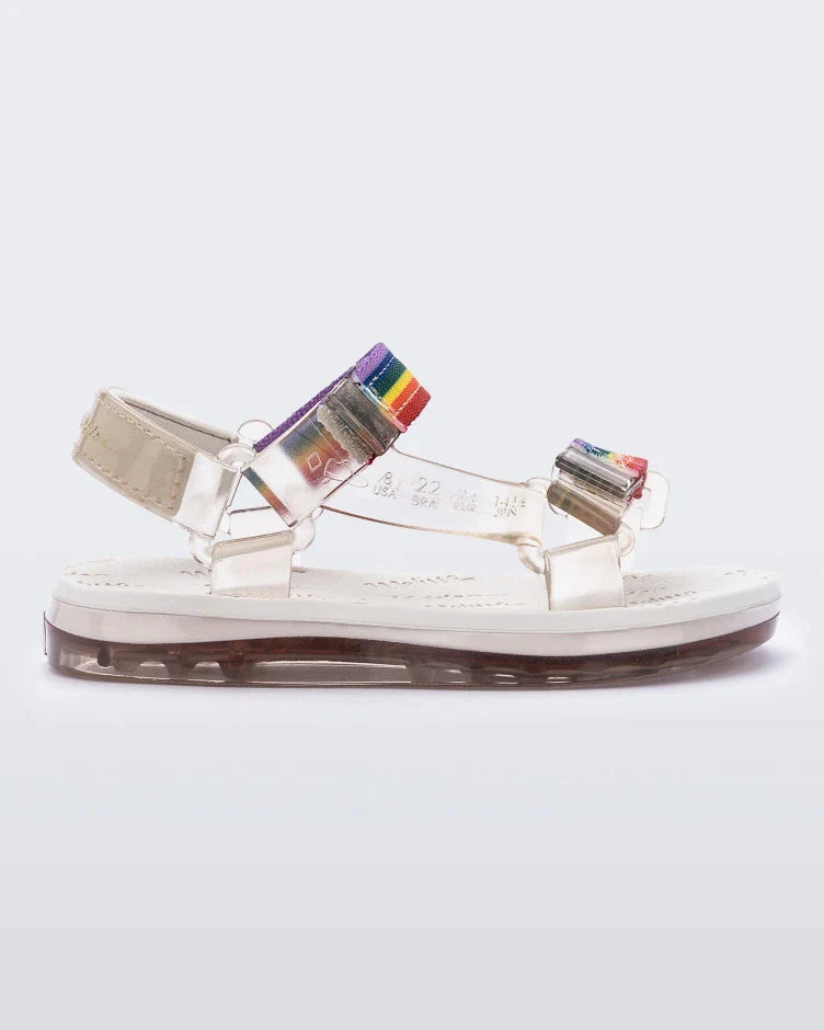 Side view of white Mini Melissa Papete sandals with rainbow straps.